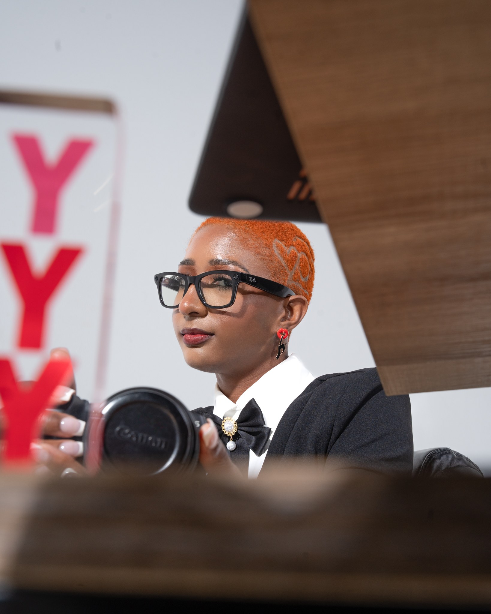 Sham holding a camera, working behind the scenes on a photography session