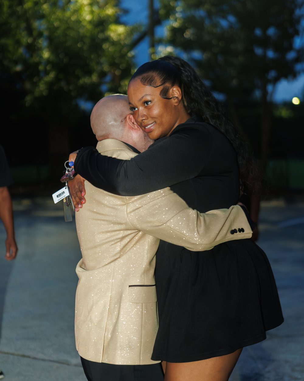 Candid hug between guests at a 50th birthday celebration