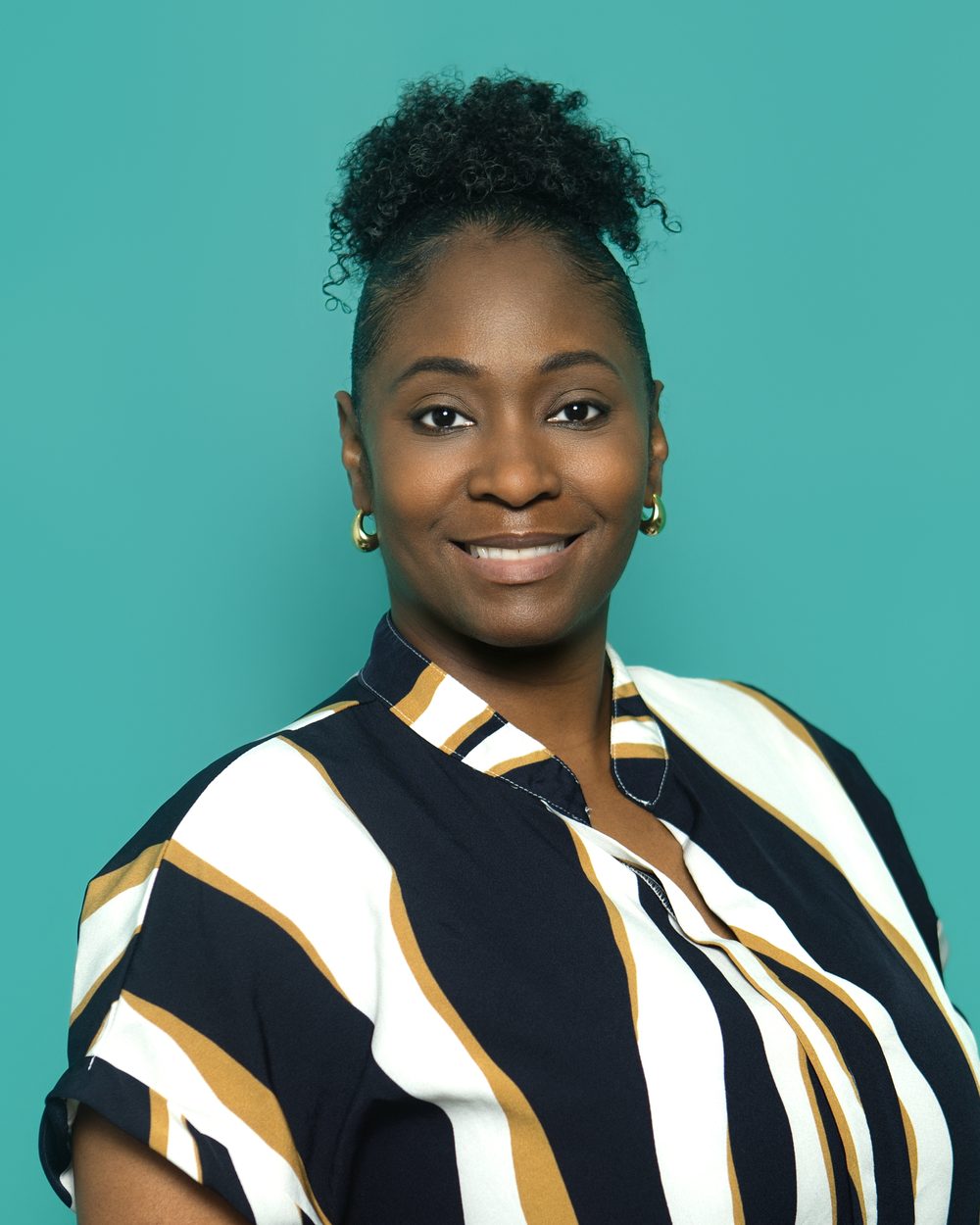 Corporate headshot, striped top, confident smile
