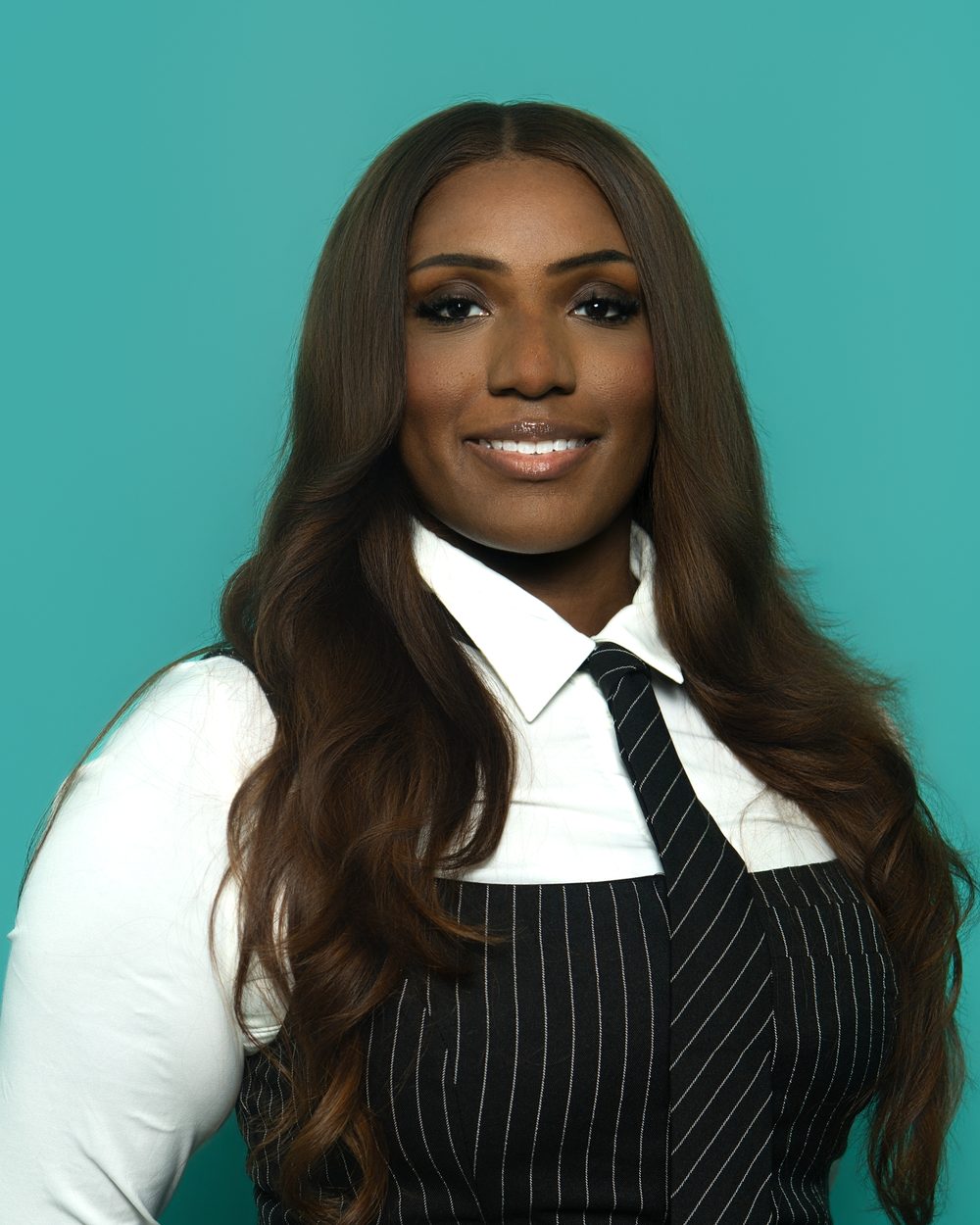 Corporate headshot, editorial styling with tie and vest