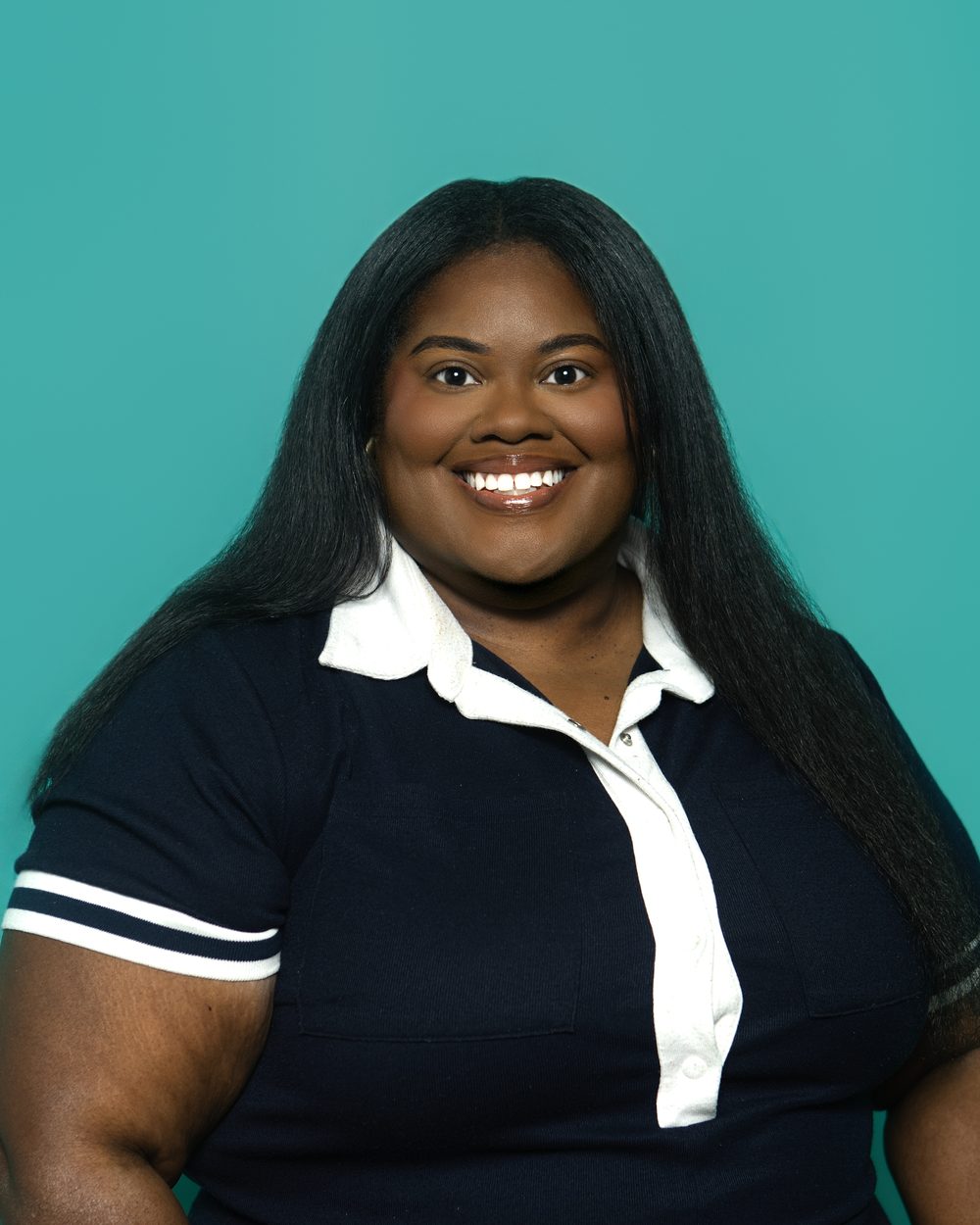 Corporate headshot, warm genuine smile