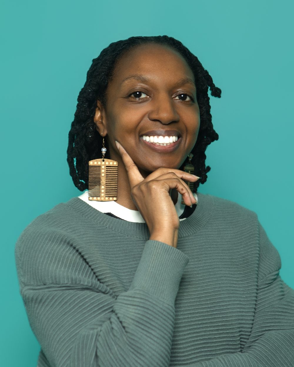Corporate headshot, playful pose with statement earrings