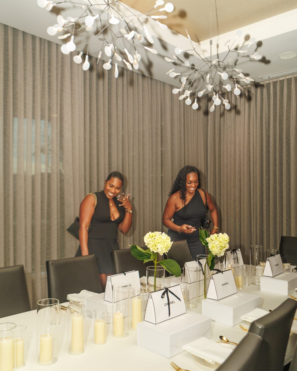Guests laughing over their personalized place cards at a bridesmaids dinner