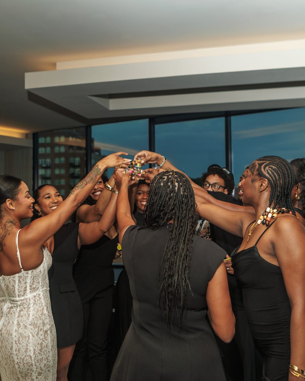 Bridesmaids raising a toast together at an engagement celebration